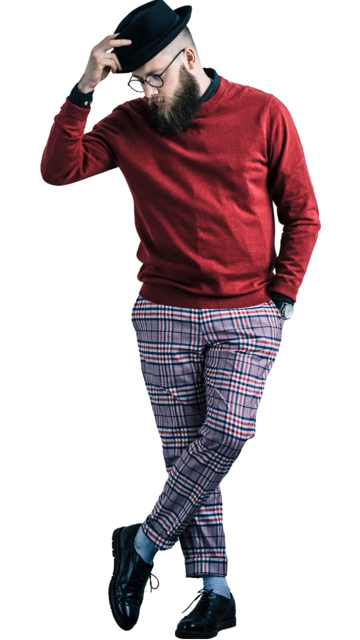 Model in a red jumper and checked trousers